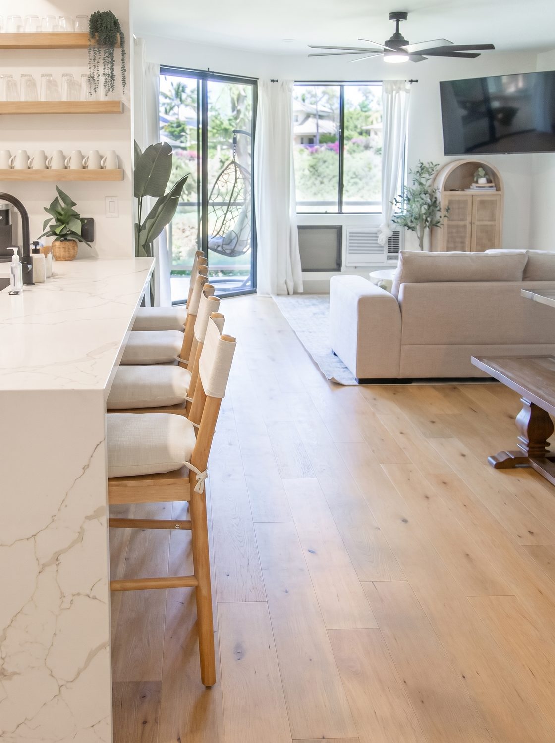 Open plan kitchen island and living room opening to a lanai